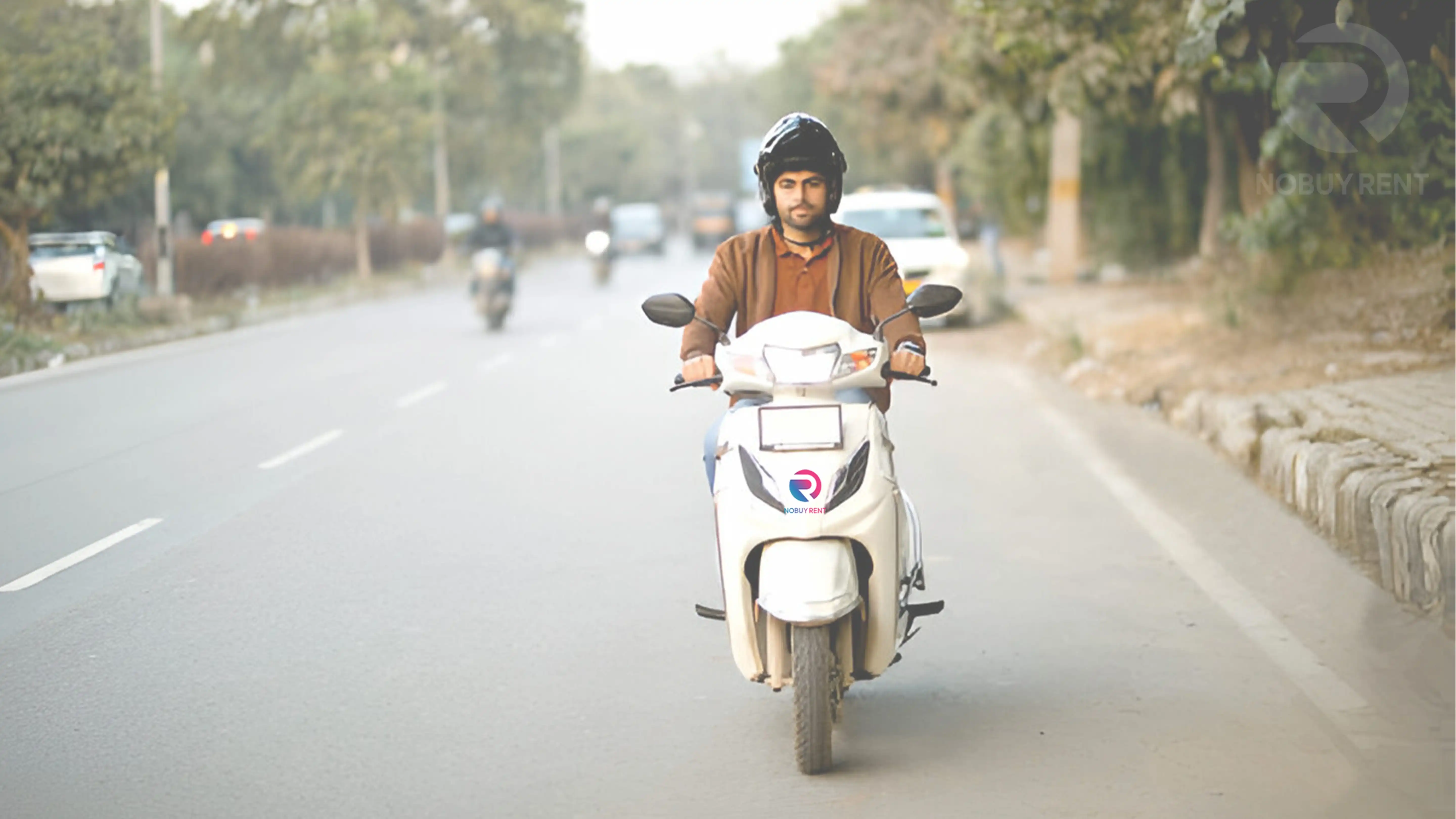 Hired electric scooter ridden by young man going down city street